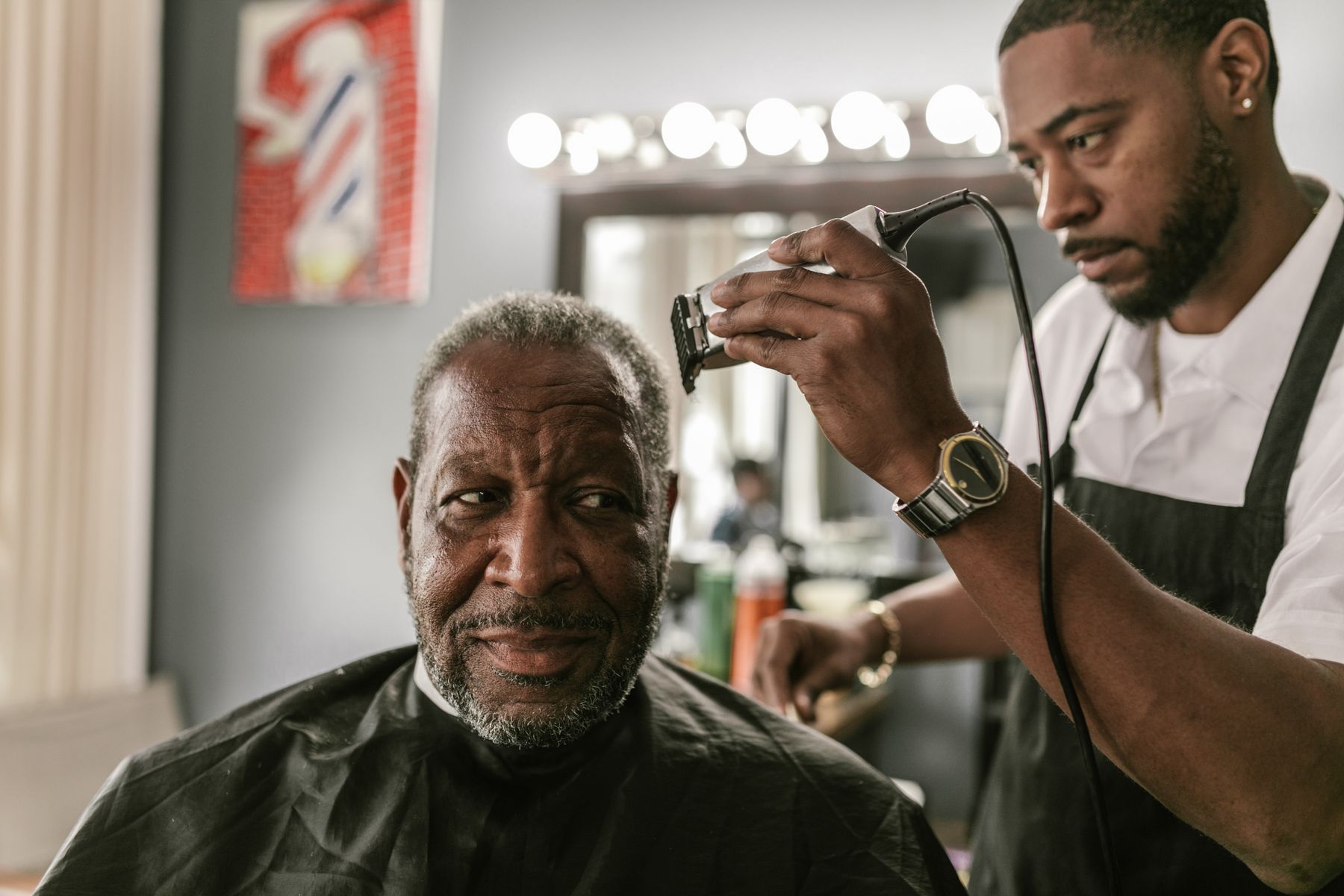 Barber trimming a client's hair with clippers